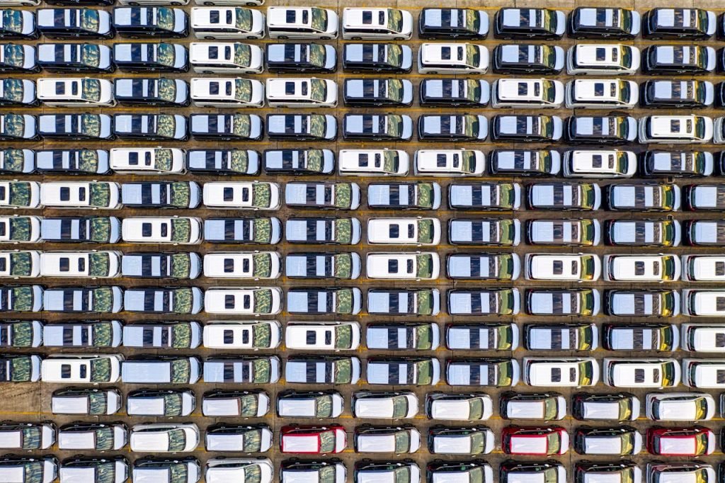 Overhead drone shot showing perfectly aligned cars parked in Jakarta, Indonesia.