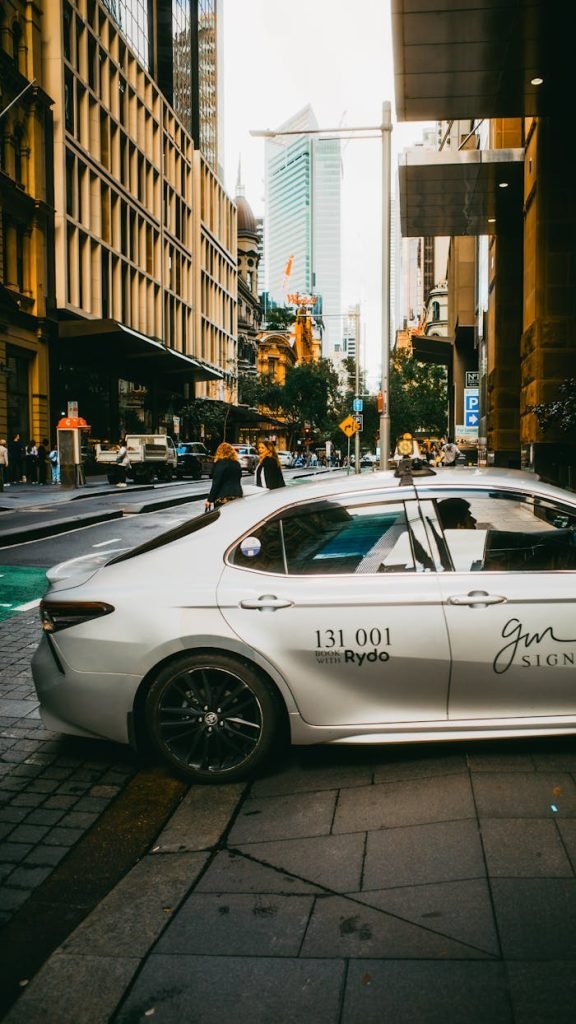 Dynamic street view in Sydneys urban area featuring a parked car and bustling cityscape.
